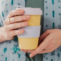 woman holding to go take out coffee cup - junk food stock pictures, royalty-free photos & images