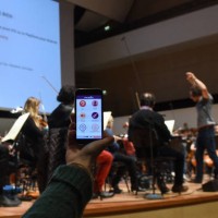 Woman holds a smartphone on January 19, 2018 during a rehearsal at the Orchestre national de Lille in the French northern city of Lille, where the...