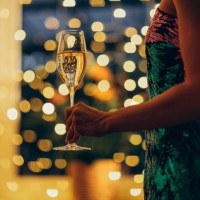 woman in a festive dress with a glass of champagne in her hand. - fashion stock pictures, royalty-free photos & images