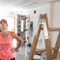 woman in her house doing renovations looks at the drywall ceiling and plans the work - home decoration stock pictures, royalty-free photos & images