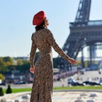 woman in long dress looking towards the eiffel tower - fashion stock pictures, royalty-free photos & images