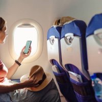 woman in the aircraft holding smart phone with white screen - travel stock pictures, royalty-free photos & images