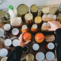 woman is rearranging the nonperishable food at the food bank - food stock pictures, royalty-free photos & images