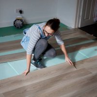 woman laying new floorboards in the living room of a house under renovation. - home decoration stock pictures, royalty-free photos & images
