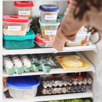 woman looking at healthy prepared meals in her fridge at home - food stock pictures, royalty-free photos & images