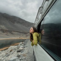 woman looking at mountains of northern pakistan from window in the van - travel stock pictures, royalty-free photos & images