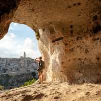 woman looking at view from a cave of matera, basilicata, italy - travel stock pictures, royalty-free photos & images