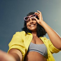 woman looking away holding sunglasses against sky - fashion stock pictures, royalty-free photos & images