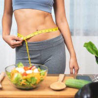woman measuring her waist - food stock pictures, royalty-free photos & images