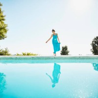 woman on pool deck of vacation home - fashion stock pictures, royalty-free photos & images