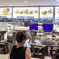 Woman ordering food at McDonalds in Plaza de Zocodover.