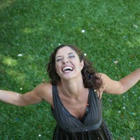 woman outdoors standing on grass with champagne and confetti smiling - garden decoration stock pictures, royalty-free photos & images