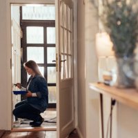 woman painting a wainscoted wall in her house. - home decoration stock pictures, royalty-free photos & images