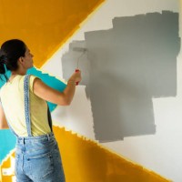 woman painting a wall at home - home decoration stock pictures, royalty-free photos & images