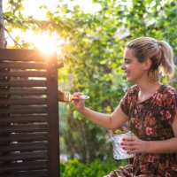 woman painting in garden at sunset - garden decoration stock pictures, royalty-free photos & images