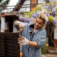 woman painting wooden blinds outdoors - home decoration stock pictures, royalty-free photos & images