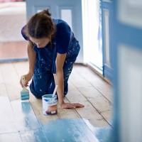 woman painting wooden floor - home decoration stock pictures, royalty-free photos & images