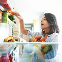 woman picking up some fruits and veggies from the fridge - food stock pictures, royalty-free photos & images