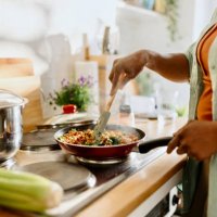 woman preparing quinoa vegetable mix cooked in a frying pan - food stock pictures, royalty-free photos & images