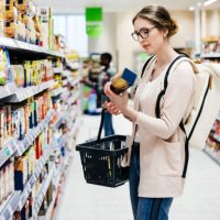 woman reading food item label in supermarket - food stock pictures, royalty-free photos & images