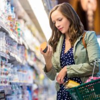 woman reading food labels at grocery store - food stock pictures, royalty-free photos & images