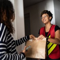 woman receiving delivery at home - junk food stock pictures, royalty-free photos & images