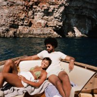 woman resting by boyfriend sitting in motorboat - travel stock pictures, royalty-free photos & images
