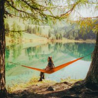 woman resting in hammock on the background of the lake in alps - travel stock pictures, royalty-free photos & images