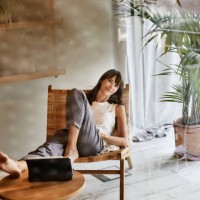 woman resting while sitting on chair at home - home decoration stock pictures, royalty-free photos & images