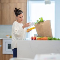 woman reviewing grocery bill - food stock pictures, royalty-free photos & images