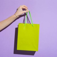 woman's hand carrying colorful shopping bag - fashion stock pictures, royalty-free photos & images