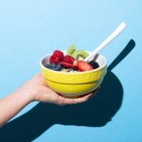 woman's hand holding bowl with muesli - food stock pictures, royalty-free photos & images