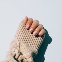 woman's hand in warm sweater showing manicure - nails art stock pictures, royalty-free photos & images
