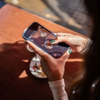 woman's hand photographing her fodd and drink in a cafeteria - food stock pictures, royalty-free photos & images