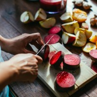 woman's hands chopping beetroot for squeezing juice - food stock pictures, royalty-free photos & images
