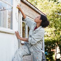 woman scraping wall during home renovation - home decoration stock pictures, royalty-free photos & images