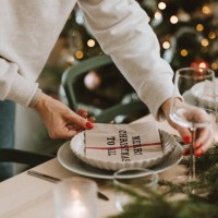 woman setting the christmas table preparing for dinner party - home decoration stock pictures, royalty-free photos & images