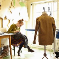 woman sewing in clothing manufacturer's workshop - fashion stock pictures, royalty-free photos & images