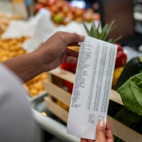 woman shopping at a supermarket and checking her receipt - food stock pictures, royalty-free photos & images