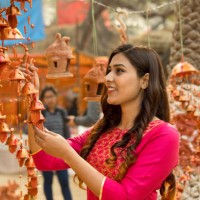 woman shopping for wall hanging at street market - home decoration stock pictures, royalty-free photos & images