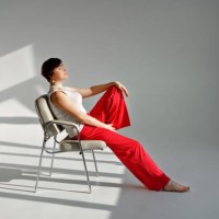 woman sitting in a modern chair - fashion stock pictures, royalty-free photos & images