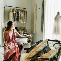 woman sitting in boutique admiring dress on mannequin in window - fashion stock pictures, royalty-free photos & images