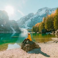 woman sitting on the background of lago di braies in winter - travel stock pictures, royalty-free photos & images