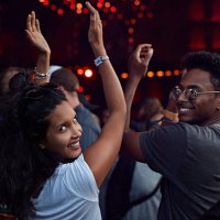 woman smiling to camera at concert - concert stock pictures, royalty-free photos & images