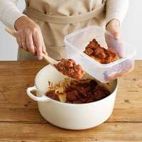 woman spooning meat into tupperware - food stock pictures, royalty-free photos & images