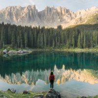woman standing and looking at lago di carezza in dolomites - travel stock pictures, royalty-free photos & images