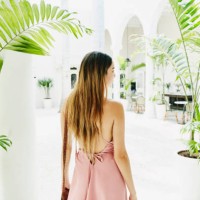 woman standing in courtyard of luxury shopping boutique - fashion stock pictures, royalty-free photos & images