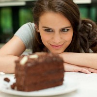 woman staring at chocolate cake - food stock pictures, royalty-free photos & images