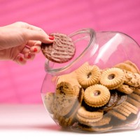 woman stealing biscuit, caught in the act. - food stock pictures, royalty-free photos & images