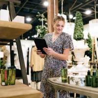 woman stocks shelves at home retail store - home decoration stockfoto's en -beelden